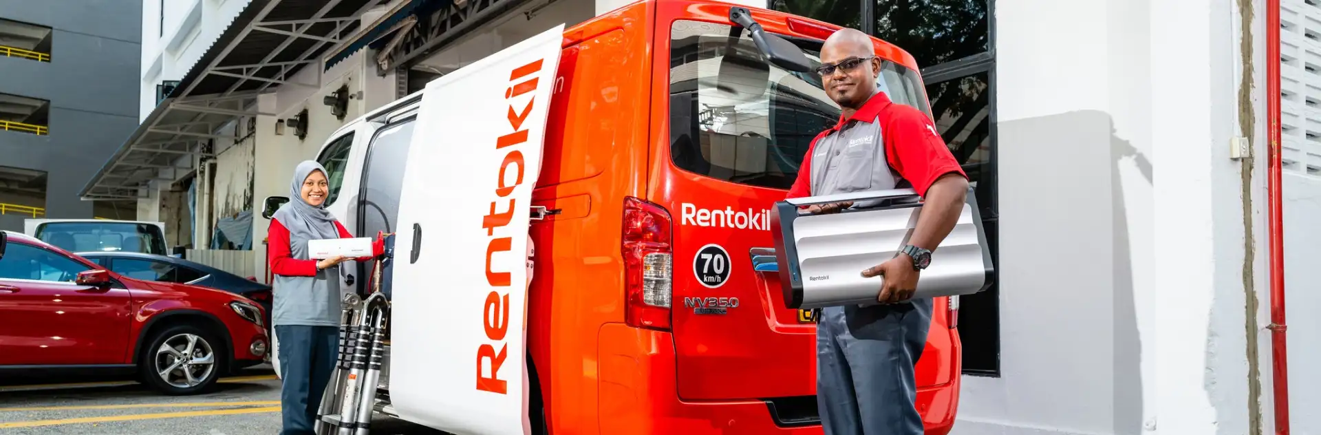 Rentokil pest control technicians retrieving gear from van