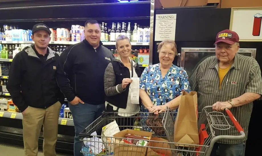 Humboldt Termite & Pest Control standing with Groceries for Good participants in Mckinleyville Grocery Outlet.