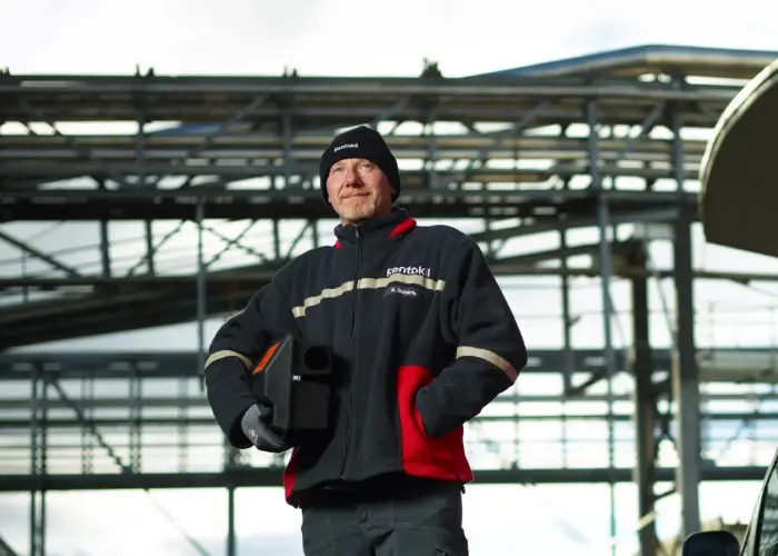 A Rentokil technician holds a rodent bait station before pest application